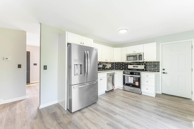 346 Princeton Ave, Bourbonnais, IL 60914 - kitchen featuring stainless steel appliances, light countertops, light wood-type flooring, tasteful backsplash, and white cabinetry