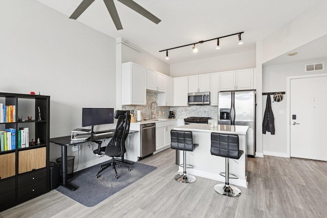 901 W Madison St Unit 1002, Chicago, IL 60607 - kitchen with stainless steel appliances, light wood finished floors, white cabinetry, and light countertops