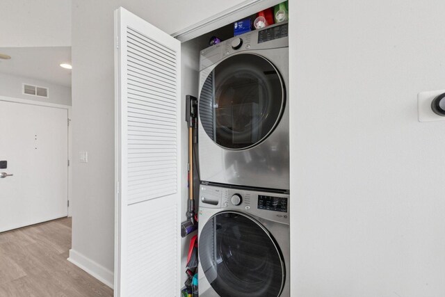 901 W Madison St Unit 1002, Chicago, IL 60607 - laundry room featuring estacked washer and dryer and wood finished floors
