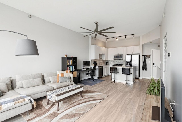 901 W Madison St Unit 1002, Chicago, IL 60607 - living area featuring light wood finished floors, a ceiling fan, rail lighting, and an office area
