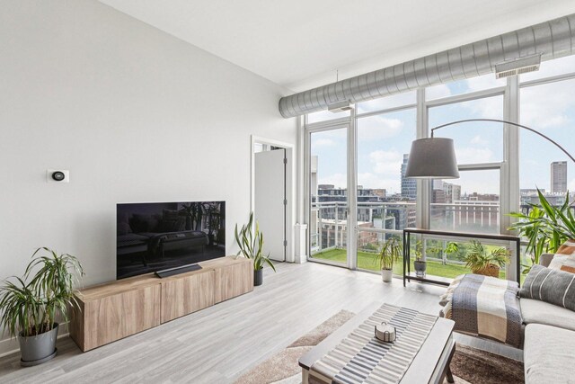 901 W Madison St Unit 1002, Chicago, IL 60607 - living room featuring expansive windows and wood finished floors