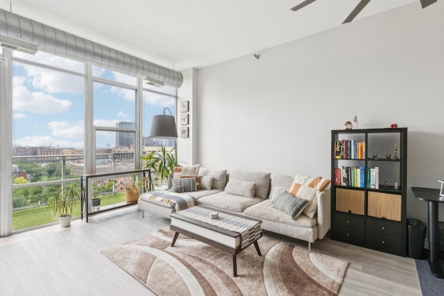 901 W Madison St Unit 1002, Chicago, IL 60607 - living area with expansive windows, wood finished floors, a view of city, and ceiling fan