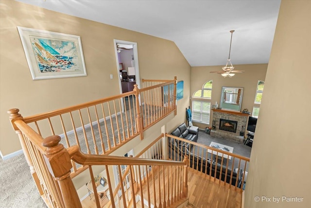 735 Chasewood Dr, South Elgin, IL 60177 - staircase featuring ceiling fan, carpet floors, lofted ceiling, and a fireplace