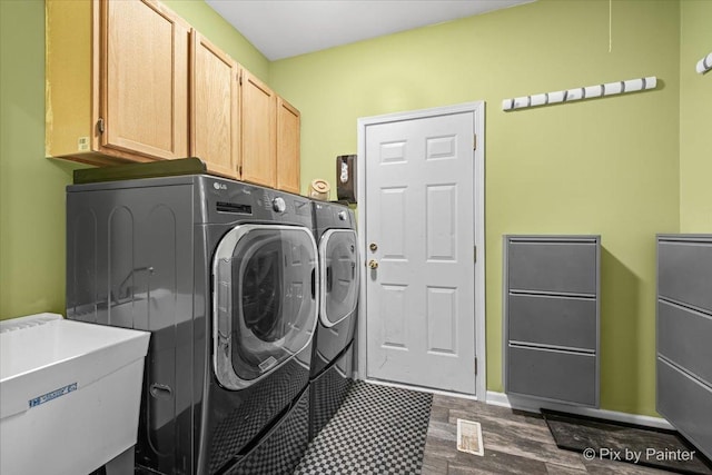 735 Chasewood Dr, South Elgin, IL 60177 - laundry area featuring independent washer and dryer, cabinet space, and dark wood finished floors