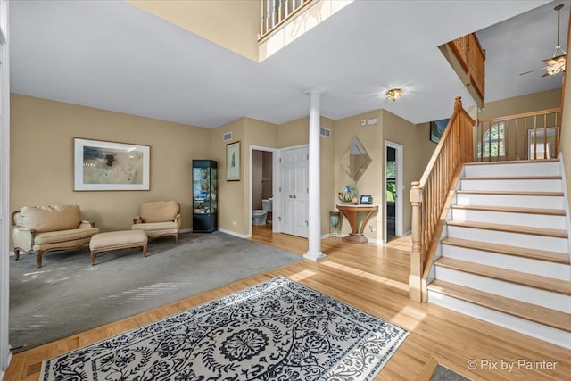 735 Chasewood Dr, South Elgin, IL 60177 - foyer featuring ornate columns, stairs, wood finished floors, and ceiling fan
