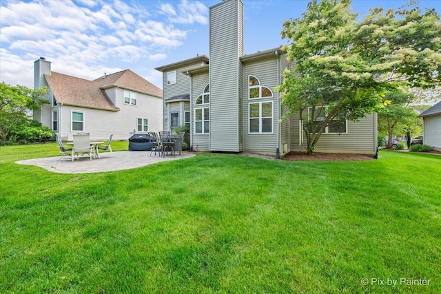 735 Chasewood Dr, South Elgin, IL 60177 - rear view of house featuring a chimney, a patio area, and a yard
