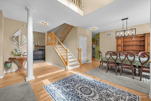 735 Chasewood Dr, South Elgin, IL 60177 - dining area featuring ornate columns, stairway, and wood finished floors