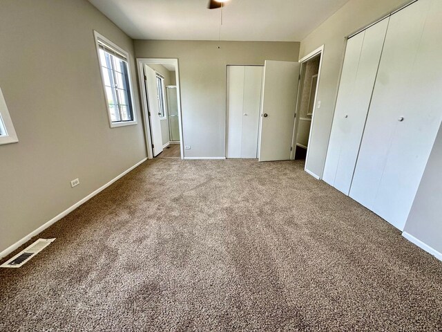 2363 Cove Dr, Hanover Park, IL 60133 - unfurnished bedroom featuring two closets, carpet floors, and ensuite bath