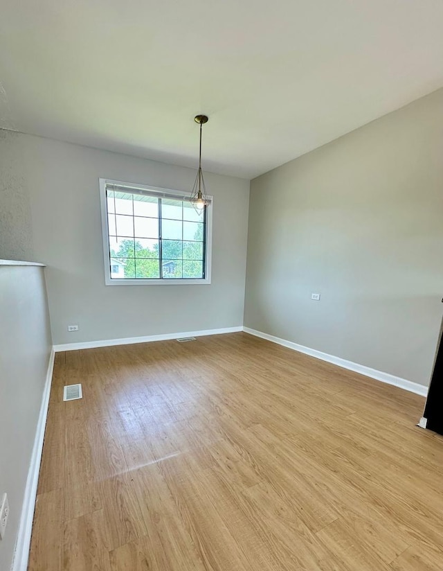 2363 Cove Dr, Hanover Park, IL 60133 - empty room with light wood-style floors and baseboards