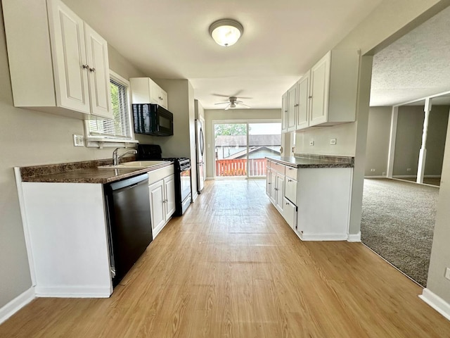 2363 Cove Dr, Hanover Park, IL 60133 - kitchen featuring stainless steel appliances, dark countertops, white cabinets, and ceiling fan