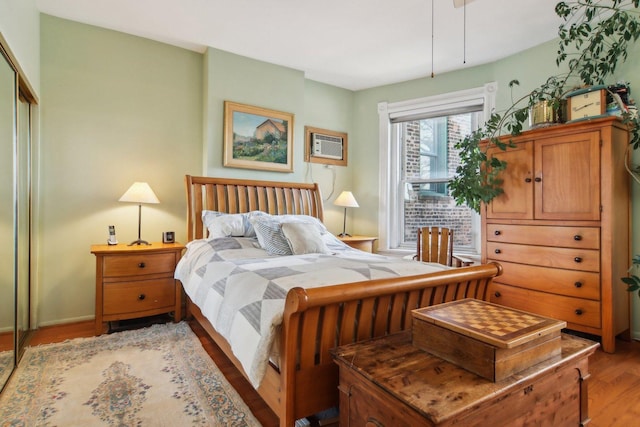 1400 N La Salle St Unit 3N, Chicago, IL 60610 - bedroom with a wall unit AC, light wood-style floors, and a closet