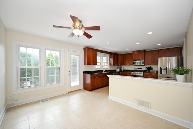 1058 Oakview Dr Unit 1058, Wheaton, IL 60187 - kitchen with stainless steel appliances, dark countertops, ceiling fan, recessed lighting, and light tile patterned flooring