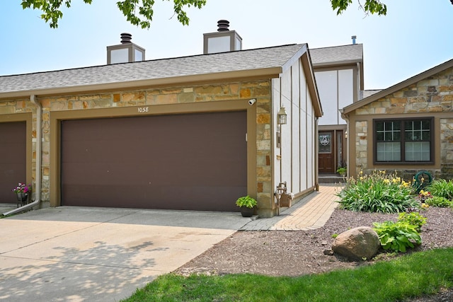 1058 Oakview Dr Unit 1058, Wheaton, IL 60187 - view of front facade featuring stone siding, driveway, an attached garage, and a shingled roof