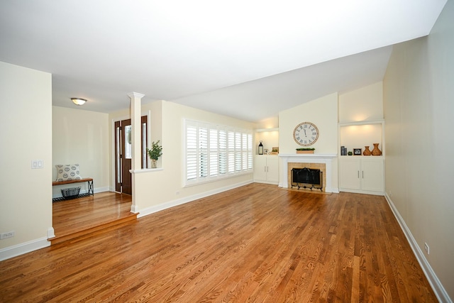 1058 Oakview Dr Unit 1058, Wheaton, IL 60187 - unfurnished living room featuring wood finished floors, a tile fireplace, and vaulted ceiling