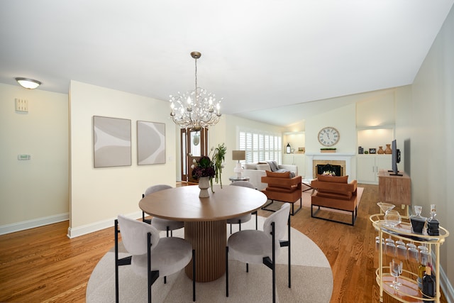 1058 Oakview Dr Unit 1058, Wheaton, IL 60187 - dining room featuring light wood-style floors, a chandelier, and a fireplace