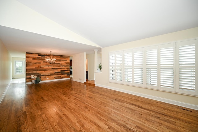 1058 Oakview Dr Unit 1058, Wheaton, IL 60187 - unfurnished living room featuring a chandelier, wood finished floors, and vaulted ceiling