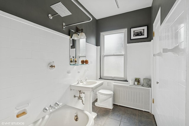 bathroom featuring radiator heating unit, tile walls, tile patterned floors, and bathtub / shower combination