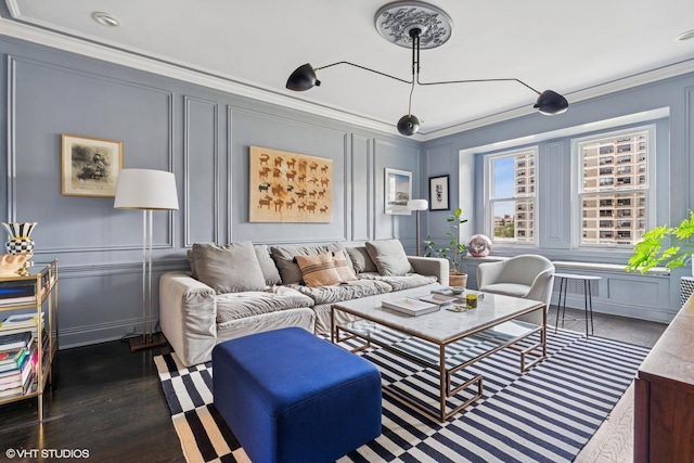 living area featuring a decorative wall, crown molding, and dark wood-type flooring