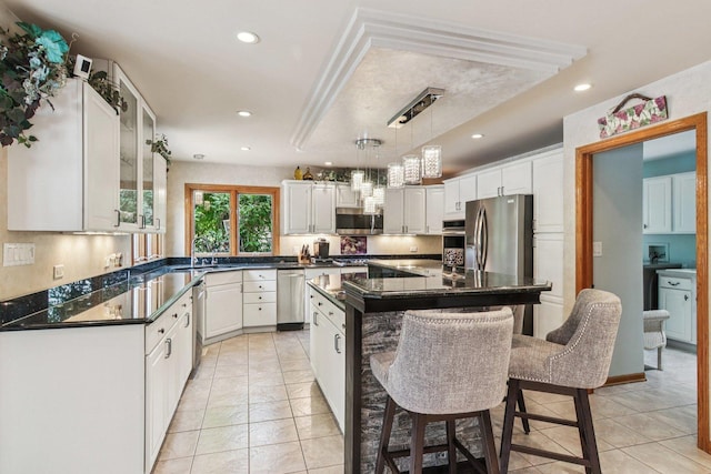 22454 Hinspeter Dr, Frankfort, IL 60423 - kitchen featuring appliances with stainless steel finishes, light tile patterned flooring, a breakfast bar, white cabinetry, and recessed lighting