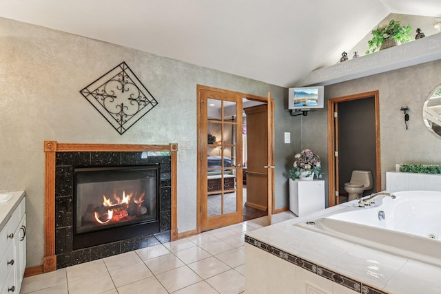 22454 Hinspeter Dr, Frankfort, IL 60423 - full bathroom with vanity, a jetted tub, lofted ceiling, a high end fireplace, and tile patterned flooring