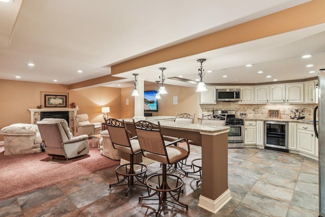 22454 Hinspeter Dr, Frankfort, IL 60423 - kitchen with stainless steel appliances, wine cooler, stone tile flooring, a kitchen bar, and recessed lighting