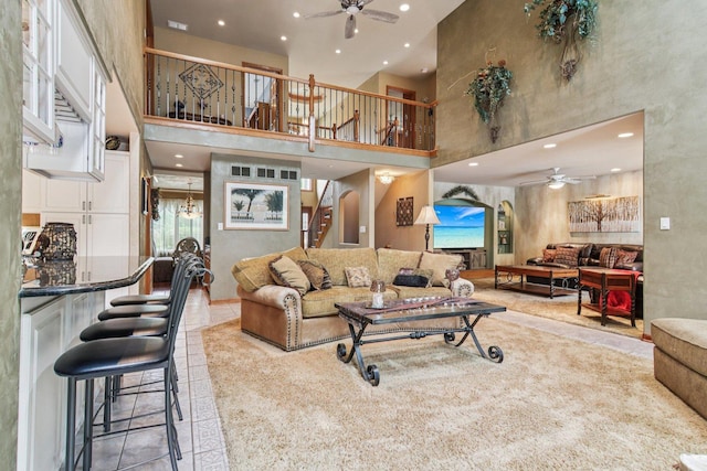 22454 Hinspeter Dr, Frankfort, IL 60423 - living room featuring ceiling fan, stairway, a towering ceiling, recessed lighting, and light carpet