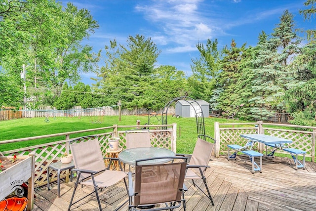 5S558 Tuthill Rd, Naperville, IL 60563 - deck featuring outdoor dining area, a storage shed, and a fenced backyard