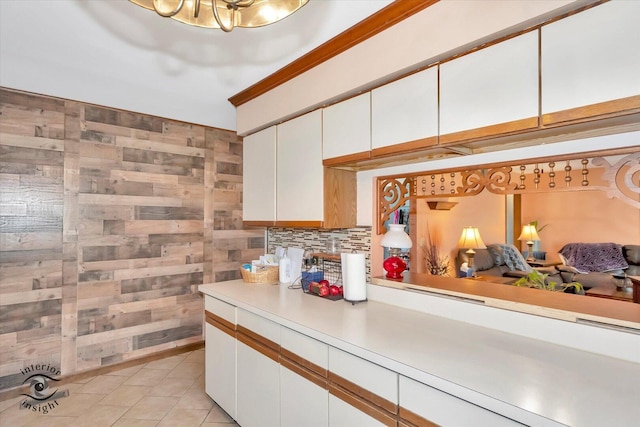 5S558 Tuthill Rd, Naperville, IL 60563 - kitchen with light countertops, white cabinetry, tasteful backsplash, light tile patterned flooring, and wooden walls