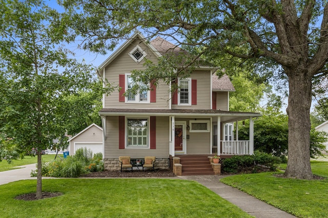 516 E Locust St, Watseka, IL 60970 - view of front of home with an outbuilding, a front lawn, a porch, and a shingled roof