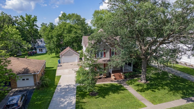 516 E Locust St, Watseka, IL 60970 - obstructed view of property with a front lawn, a detached garage, and a porch