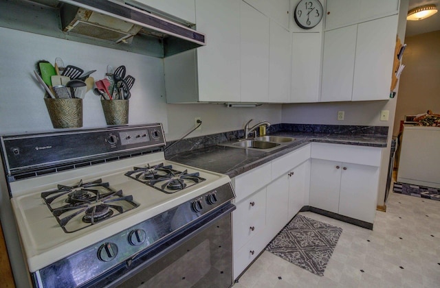 220 N Indiana St, Atwood, IL 61913 - kitchen with white range with gas stovetop, white cabinetry, range hood, and dark countertops