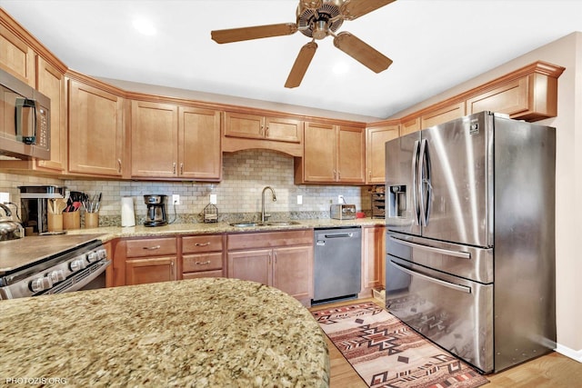 226 S Rathje Rd, Peotone, IL 60468 - kitchen featuring appliances with stainless steel finishes, light wood-style flooring, light stone counters, and ceiling fan