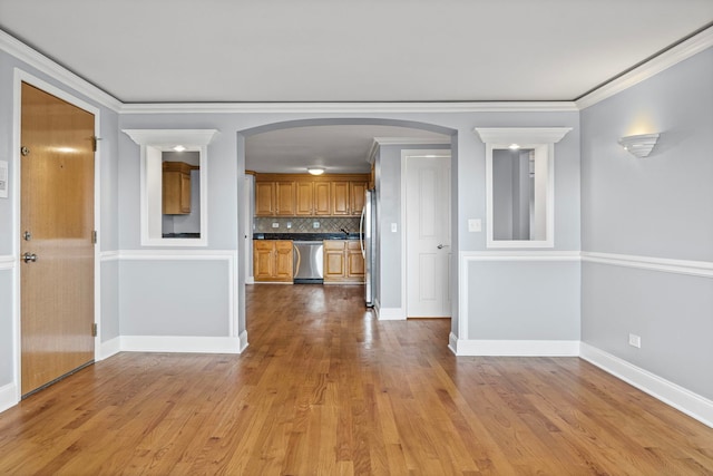 9633 Brandy Ct Unit 6, Des Plaines, IL 60016 - kitchen with stainless steel appliances, brown cabinetry, light wood finished floors, backsplash, and arched walkways