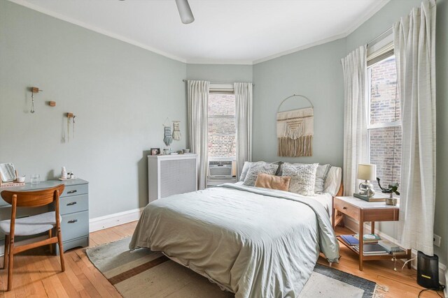 4706 N Paulina St, Chicago, IL 60640 - bedroom featuring multiple windows, light wood-style floors, crown molding, cooling unit, and a ceiling fan