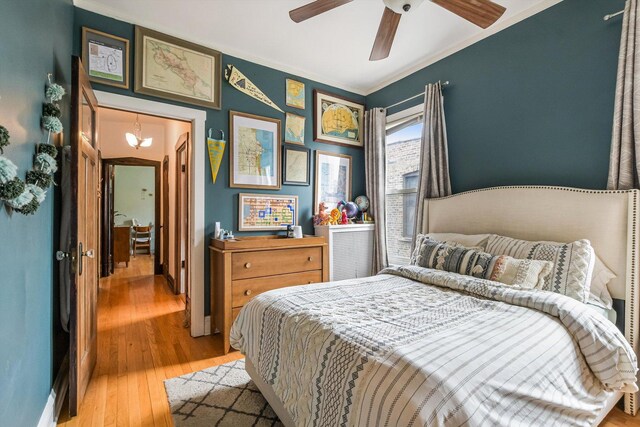 4706 N Paulina St, Chicago, IL 60640 - bedroom with light wood-type flooring, ornamental molding, and a ceiling fan