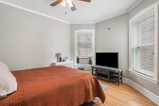 4706 N Paulina St, Chicago, IL 60640 - bedroom featuring light wood-style floors, multiple windows, crown molding, cooling unit, and a ceiling fan