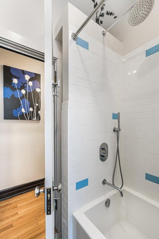 4706 N Paulina St, Chicago, IL 60640 - bathroom featuring washtub / shower combination and wood finished floors