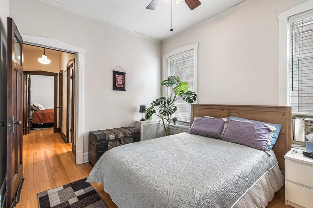 4706 N Paulina St, Chicago, IL 60640 - bedroom featuring crown molding, light wood-style flooring, multiple windows, and ceiling fan