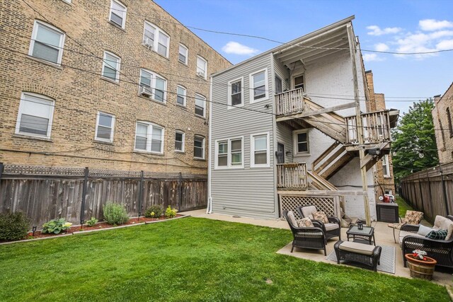 4706 N Paulina St, Chicago, IL 60640 - rear view of house featuring a fenced backyard, outdoor lounge area, stairs, and a patio