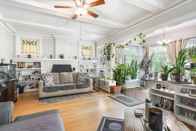 4706 N Paulina St, Chicago, IL 60640 - living room featuring a ceiling fan, wood finished floors, a chandelier, beam ceiling, and a brick fireplace