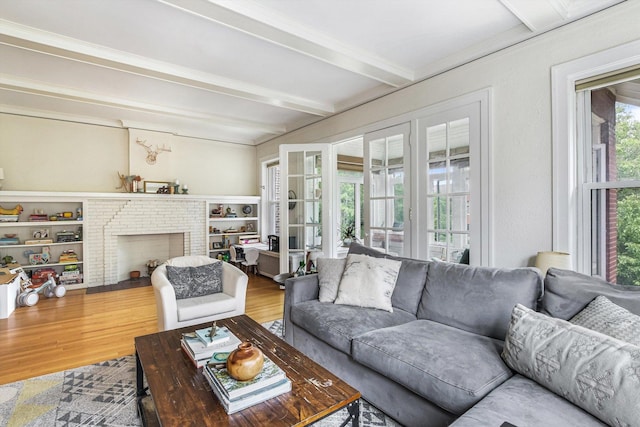 4706 N Paulina St, Chicago, IL 60640 - living area with wood finished floors, beamed ceiling, a fireplace, and ornamental molding