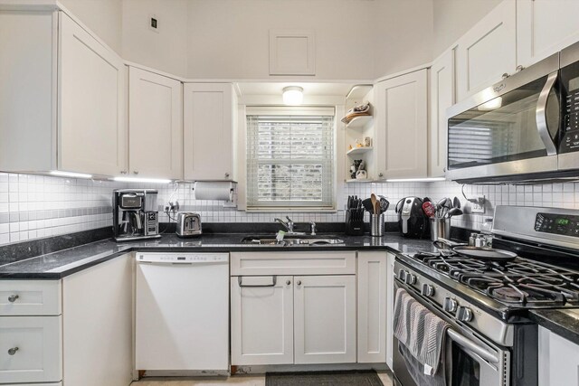 4706 N Paulina St, Chicago, IL 60640 - kitchen with appliances with stainless steel finishes, white cabinetry, and dark countertops