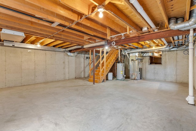 212 Jake Ln, Hampshire, IL 60140 - unfinished below grade area with gas water heater, stairway, and heating unit