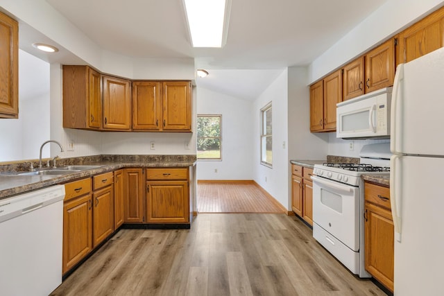 212 Jake Ln, Hampshire, IL 60140 - kitchen with white appliances, lofted ceiling, light wood finished floors, brown cabinets, and dark countertops