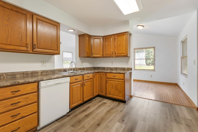 212 Jake Ln, Hampshire, IL 60140 - kitchen with dishwasher, brown cabinets, dark countertops, light wood finished floors, and vaulted ceiling