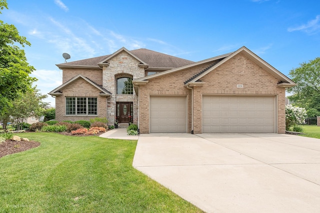 2024 Taller Rd, Morris, IL 60450 - french country inspired facade with concrete driveway, an attached garage, a front lawn, brick siding, and stone siding