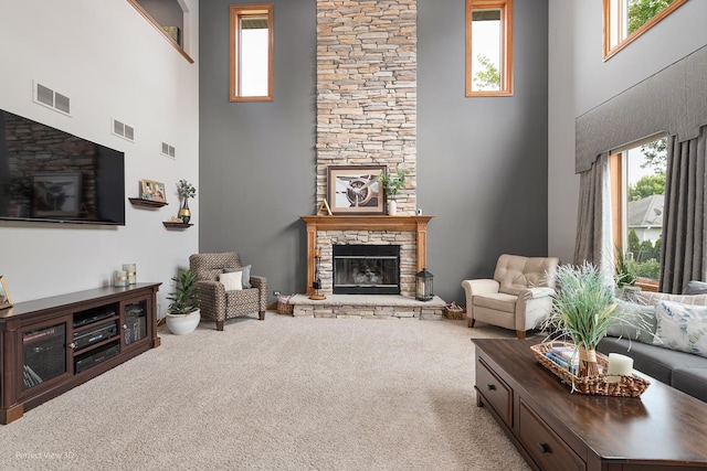 2024 Taller Rd, Morris, IL 60450 - living room with a fireplace, a towering ceiling, healthy amount of natural light, and carpet floors