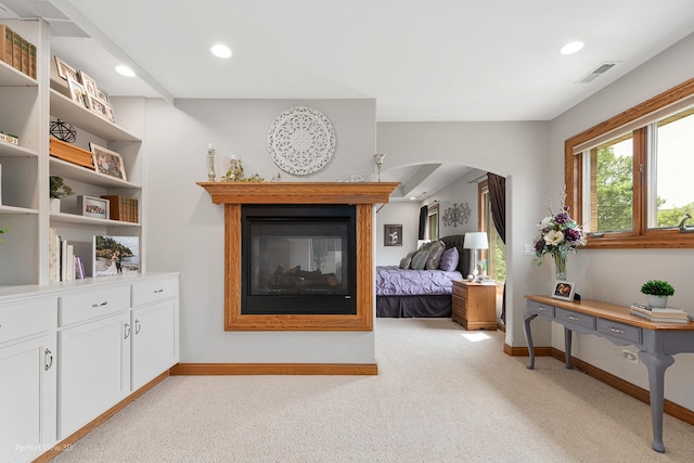 2024 Taller Rd, Morris, IL 60450 - bedroom with light carpet, recessed lighting, arched walkways, and a multi sided fireplace