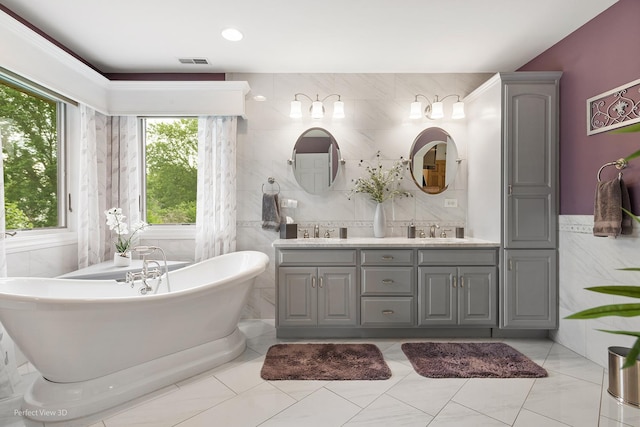 2024 Taller Rd, Morris, IL 60450 - bathroom with double vanity, a soaking tub, and tile walls