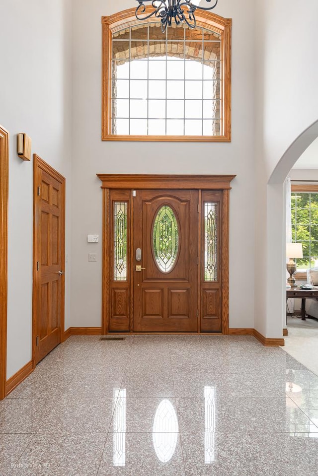 2024 Taller Rd, Morris, IL 60450 - foyer with a high ceiling, granite tiled floors, arched walkways, and a chandelier